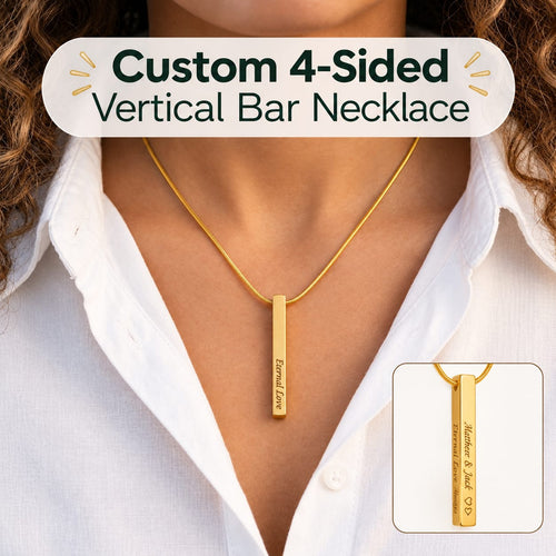 A close-up of a model wearing a gold vertical bar necklace with a matching chain. The necklace has a rectangular pendant engraved with personalized text.